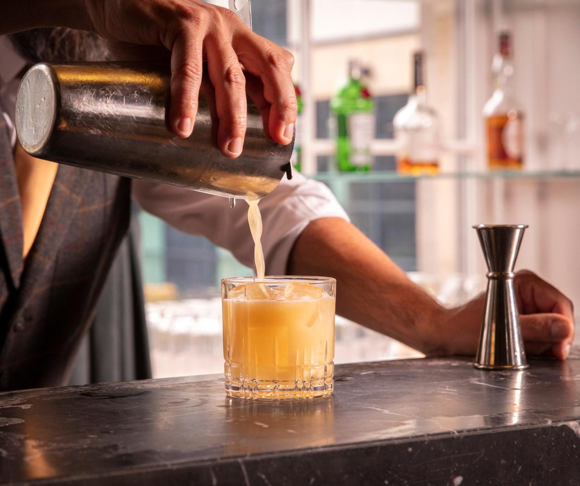 Schloss Roxburghe, Part Of Destination By Hyatt 외부 사진 A bartender straining a cocktail